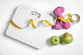 Composition with scales, apples, tape measure and dumbbells Royalty Free Stock Photo