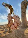 Composition of sea shells collected on a rope in the form of beads hangs on a fancy driftwood on the sea