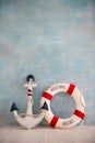 A composition on a sea theme with an anchor and lifebuoy on a blue wall Royalty Free Stock Photo