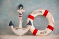 A composition on a sea theme with an anchor and lifebuoy on a blue wall Royalty Free Stock Photo