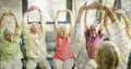 Composition of senior group practicing yoga with instructor and autumn foliage