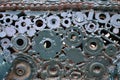 A composition of a set of gears and car parts that are welded to each other and painted green. Grunge steampunk textur Royalty Free Stock Photo