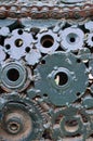 A composition of a set of gears and car parts that are welded to each other and painted green. Grunge steampunk textur Royalty Free Stock Photo