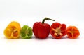 Composition of several halves of ripe sweet pepper of different colors on a light background.