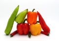 Composition of several types of sweet pepper of different shapes, colors and sizes on a light background.