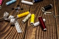 A composition of sewing items with various spools of colored thread, buttons, tape measure, scissors, a needle with threaded Royalty Free Stock Photo