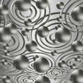 Composition of shiny metal balls and rings on a gray gradient background.