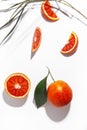 Composition of Sicilian oranges, whole and cut on a white background