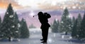 Composition of silhouette of santa claus playing golf over winter landscape Royalty Free Stock Photo