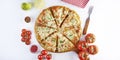 Sliced pizza with ingredients on white background. Top view, flat lay with copy space Royalty Free Stock Photo