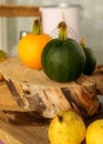 Composition of small pumpkins and apples, wooden disc base, Halloween time