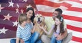 Composition of smiling caucasian couple with son and daughter and pet dog against american flag Royalty Free Stock Photo