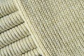 Composition of a soft yellow knitted sweater. Macro texture of bindings in yarns