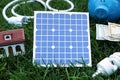 Composition with solar panel, house model and lightbulb Royalty Free Stock Photo