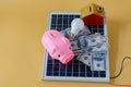 Composition with solar panel, led lamp, money and piggy bank Royalty Free Stock Photo