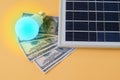 Composition with solar panel, led lamp, money Royalty Free Stock Photo