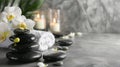 Composition of spa settings with orchid on gray background, spa stones, towels and orchid on grey Royalty Free Stock Photo