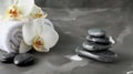 Composition of spa settings with orchid on gray background, spa stones, towels and orchid on grey Royalty Free Stock Photo