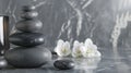 Composition of spa settings with orchid on gray background, spa stones, towels and orchid on grey Royalty Free Stock Photo