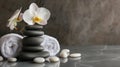 Composition of spa settings with orchid on gray background, spa stones, towels and orchid on grey Royalty Free Stock Photo