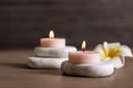 Composition of spa stones, flower and burning candles