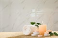 Composition of spa stones,  and burning candles on bamboo mat, space for text Royalty Free Stock Photo