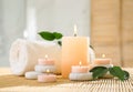 Composition of spa stones, towel and burning candles Royalty Free Stock Photo