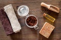 Composition of spa treatment. Coffee scrub, coffee soap, salt and oil on wooden table background top view