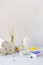 Composition of spa wellness products on white background. with towel,white lily, sea salt, bath oil, sugar body scrub Royalty Free Stock Photo