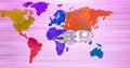 Composition of space rocket on multi coloured world map over pink stripes in background