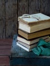 The composition of a stack of old books and glasses on a wooden background. Vintage photo. Royalty Free Stock Photo