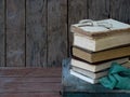 The composition of a stack of old books and glasses on a wooden background. Vintage photo. Side view. copy space Royalty Free Stock Photo