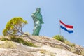 Statue of St. Peter, fallen tree and flag of Croatia Royalty Free Stock Photo