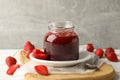 Composition strawberry jam on wooden table against gray background Royalty Free Stock Photo