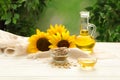 Composition with sunflower oil on white wooden table against blurred background Royalty Free Stock Photo