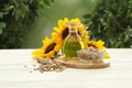 Composition with sunflower oil on white wooden table against blurred background Royalty Free Stock Photo