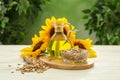 Composition with sunflower oil on white wooden table against blurred background Royalty Free Stock Photo