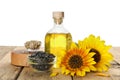 Composition with sunflower oil on wooden table against white background Royalty Free Stock Photo