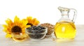 Composition with sunflower oil on wooden table against white background Royalty Free Stock Photo