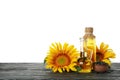 Composition with sunflower and oil on table isolated on white background Royalty Free Stock Photo