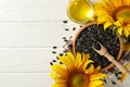 Composition with sunflower, seeds and oil on white wooden Royalty Free Stock Photo