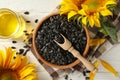 Composition with sunflower, seeds and oil on wooden background Royalty Free Stock Photo