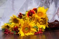 Composition with sunflowers, daisies and red viburnum