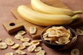 Composition with sweet dried banana slices, fresh bananas. Top view with space for text. Dried fruit as healthy snack. Royalty Free Stock Photo