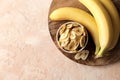 Composition with sweet dried banana slices, fresh bananas. Top view with space for text. Dried fruit as healthy snack. Royalty Free Stock Photo