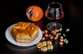 Composition of sweets, nuts, fruits and a drink in a glass.