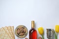 Composition with symbolic Passover Pesach items on white background, top view.