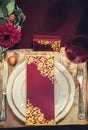 Composition on the table from table setting, fork, knife, glass, white plate with a holiday card Royalty Free Stock Photo