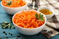 Composition tasty carrot salad on wooden background. Korean carrot