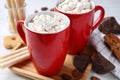 Composition of tasty cocoa with marshmallows in cups on wooden table Royalty Free Stock Photo